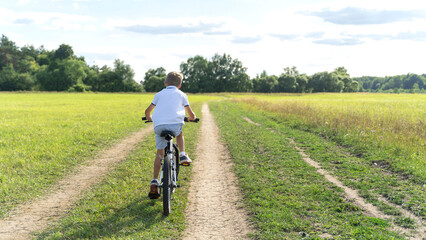 boy riding a bike in the park