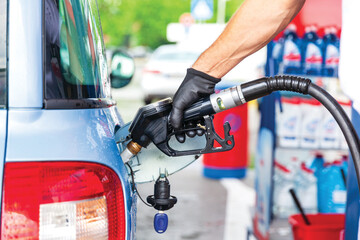 Fill up a car with gasoline or diesel fuel at petrol station