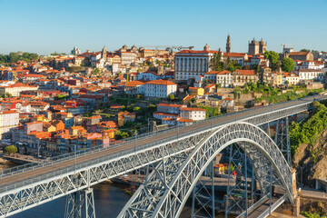 Dom Luis bridge in Porto, Portugal. Old town skyline from Gaia city on Douro river with colorful buildings and bridge