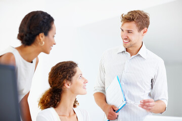 Business man discussing with female colleagues. Business man with file and glasses discussing with two female colleagues.