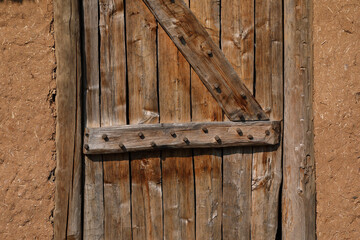 A close-up of an old and weathered wooden door
