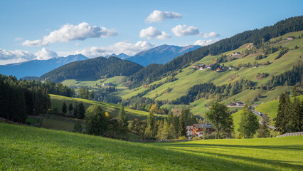 Fototapeta na wymiar Panoramic image of the green valleys of Alpe di Siusi, Dolomites, Italy