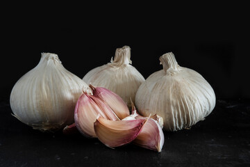 Garlic and garlic cloves isolated on a black background