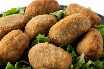 Traditional spanish fried croquettes isolated on white background. Close up