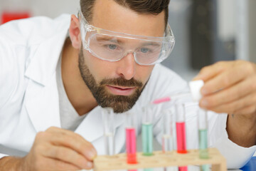 man using pipette in lab