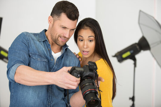 photographer and model reviewing photographs on the camera