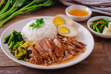 Stewed pork leg with boiled egg and rice on plate