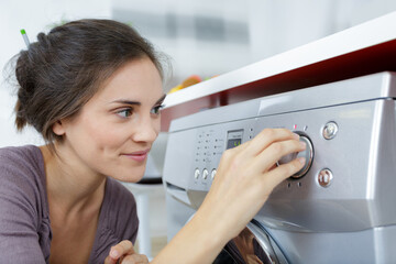 woman putting washing machine on