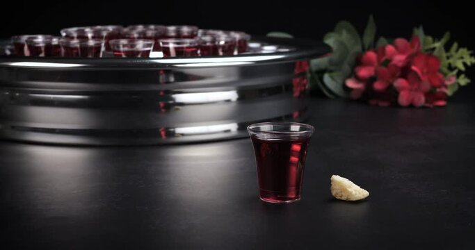 Taking communion concept - the wine and the bread symbols of Jesus Christ blood and body. Easter Passover and Lord Supper concept. Dolly shot 4k