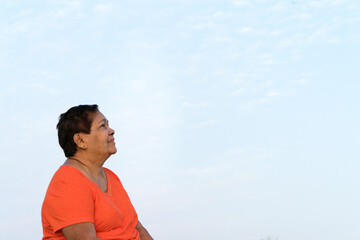 Portrait of senior woman looking away at the sky