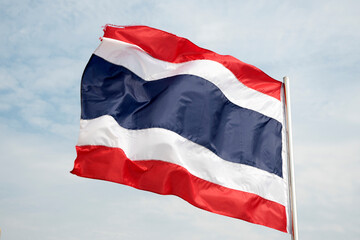 Fototapeta na wymiar Thailand flag waving in wind with beautiful blue sky