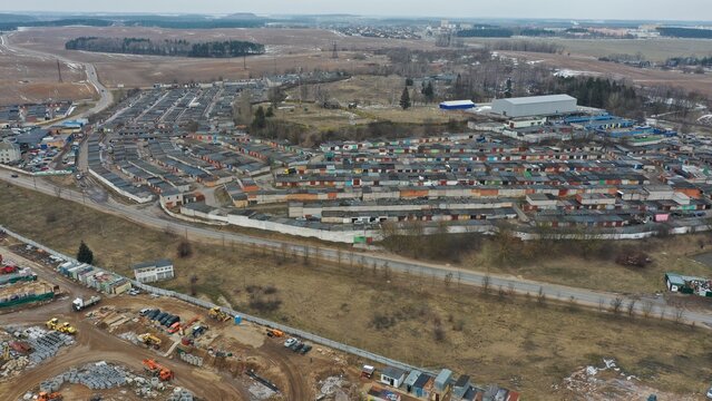 Huge garage cooperative with car storage boxes. A complex of private garages and auto repair shops for thousands of cars, filmed from a drone from a height. Car storage in Eastern Europe and Russia