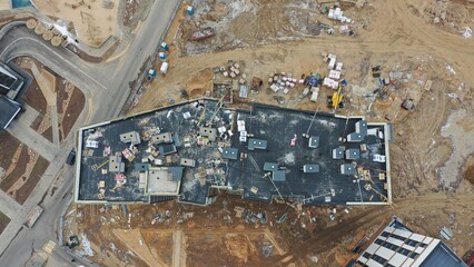 Vertical view down from above on the roof of a multi-storey residential building under...