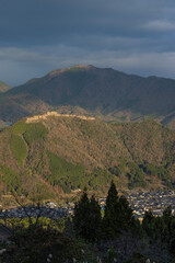 Fototapeta na wymiar 日本　兵庫県朝来市の立雲峡テラスから見える早朝の朝日に照らされた竹田城跡