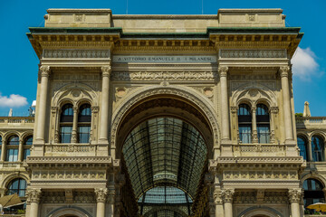 Obraz premium Milan, Italy Galleria Vittorio Emanuele II facade at Piazza del Duomo. Day view of historic mall entrance at Duomo square.