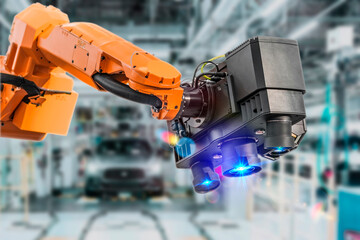 Industrial 3D laser scanner on robotic arm on background of car manufacturing factory. Automated...