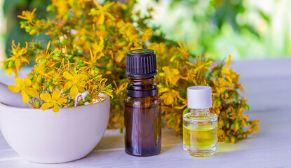 St. John's wort essential oil in a small bottle. Selective focus.