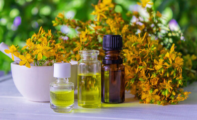 St. John's wort essential oil in a small bottle. Selective focus.