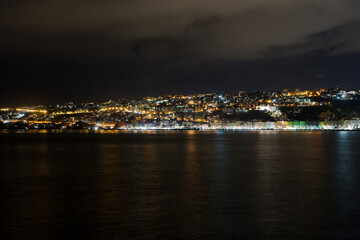 Fototapeta na wymiar Naples, Italy promenade and city night view. Mergellina coastal section seen from the waterfront at the gulf of Napoli.