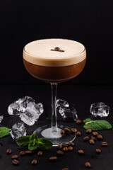Elegance cocktail with coffee beans on black background