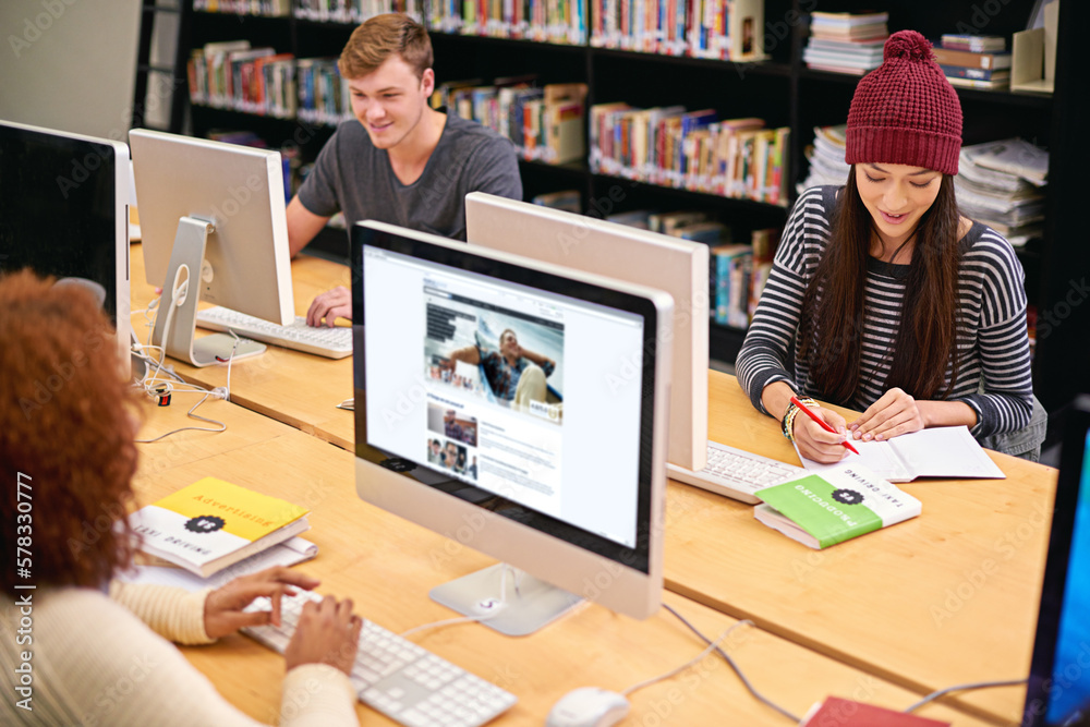 Poster Fill your mind with knowledge. students working on computers in a university library.