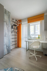 Stylish interior of a teenager number with a workplace and a sports corner