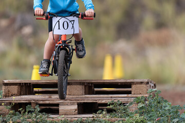 BMX rider competing in the child class, mountain bike hard tail