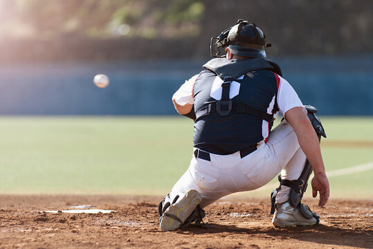 Baseball catcher during game, baseball catcher reaching to catch ball	