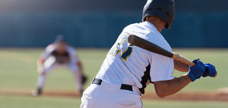 Baseball players in action on the stadium, baseball batter waiting to strike the ball	