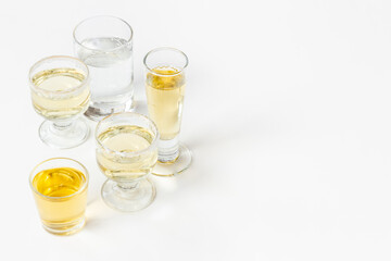 Alcoholic drinks in glasses with ice. Strong alcohol background