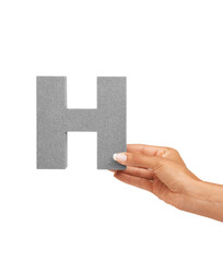 Learn your letters H. A young woman holding a capital letter H isolated on a white background.