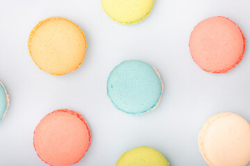 Macaroons, baked sweets from the pastry shop on blue background, top view