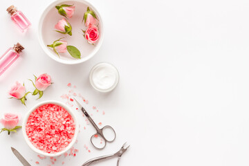 Obraz na płótnie Canvas Pink roses flowers and manicure tools. Beauty nail care spa salon.