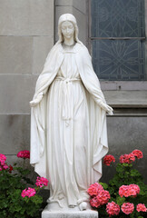 Old Marble Statue of The Virgin Mary with Geraniums in Indianapolis, IN, USA