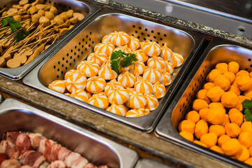 Selective focus on plenty choices of meat in pots for traditional charcoal grill BBQ style in all you can eat buffet.