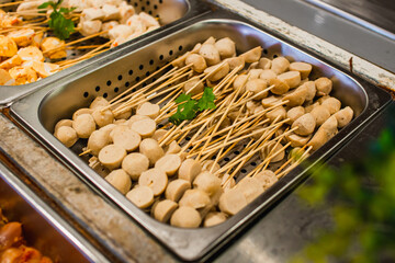 Selective focus on plenty choices of meat in pots for traditional charcoal grill BBQ style in all you can eat buffet.