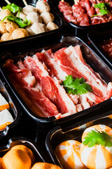 Selective focus on plenty choices of meat in pots for traditional charcoal grill BBQ style in all you can eat buffet.