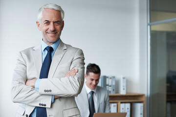 Fototapeta premium Hes got success on the agenda. Portrait of an older businessman with his arms crossed in a board room.