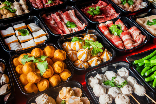 Selective focus on plenty choices of meat in pots for traditional charcoal grill BBQ style in all you can eat buffet.