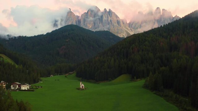 Scenic landscape from Santa Maddalena valley with Olde peaks of the Dolomites with magic pink sunset. 