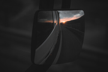 truck reflection in the mirror with sunrise