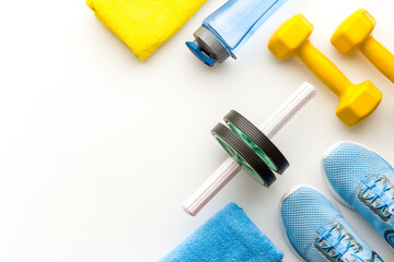 Sport background with sneakers and dumbbells, top view