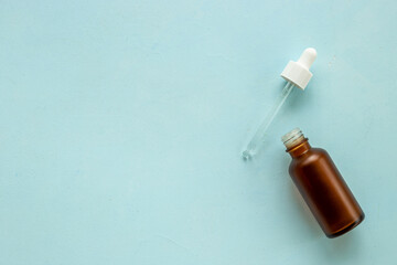 Essential serum oil in dropper bottle. Cosmetic products background