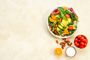 Bowl full of healthy vegetarian salad with avocado and tomatoes