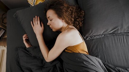 Serene sleeping woman sleeping in an orthopedic bed