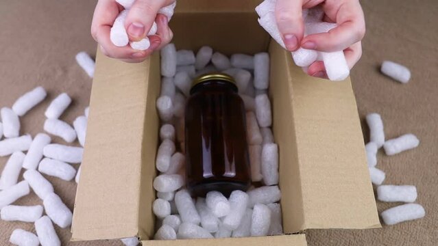 Eco package of parcels and biodegradable filler. Box is filled with a filler that does not harm the environment. Delivery of goods, parcels, delivery service, nature protection.  Recycling