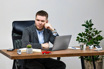 man sitting on chair at table and resting, using laptop