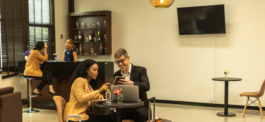 Two business workers are waiting and taking facility service at an exclusive airline lounge....