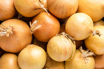 Overhead shot of white onions in box on rustic wooden table. Close up