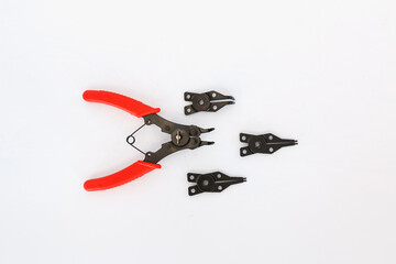circlip pliers with red handles on a white background